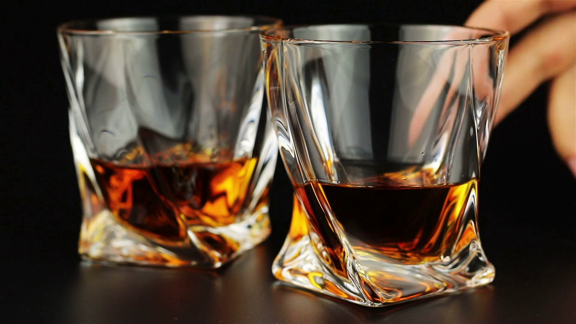 young-man-drinking-whiskey-over-black-background_sllqxswj9_thumbnail-full01.png