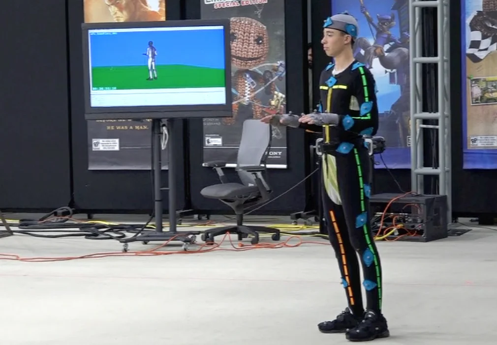 Max in motion capture suit w avatar on monitor.jpg