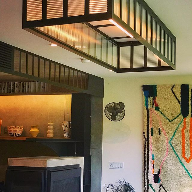 This dining room box light continues the simple, somewhat industrial theme of the parlor floor of this townhome - laser-cut plate steel, filleted rectangular openings, fluted glass. The dual linestra bulbs were a perfect fit.