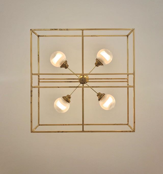 Our brass cage chandeliers were designed in 2x2, 3x3 or 4x4 foot formats. The central fixture of dimmable LED bulbs in fluted acrylic globes is suspended within a welded brass square tube cage. To be more precise - the brass was MIG-brazed using sili