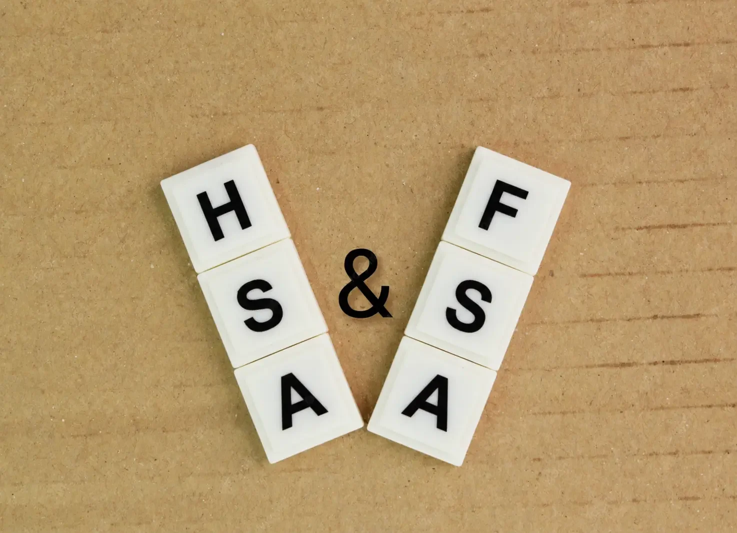 Letter tiles spelling HSA and FSA