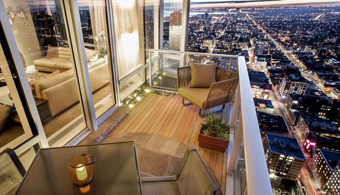 This balcony was originally designed for a model suite. The combination of wood and stone decking with cobble rock and lighting borders proved irresistible for the art dealer who snapped it up when he first visited the suite on the 51st floor overlooking University Avenue.