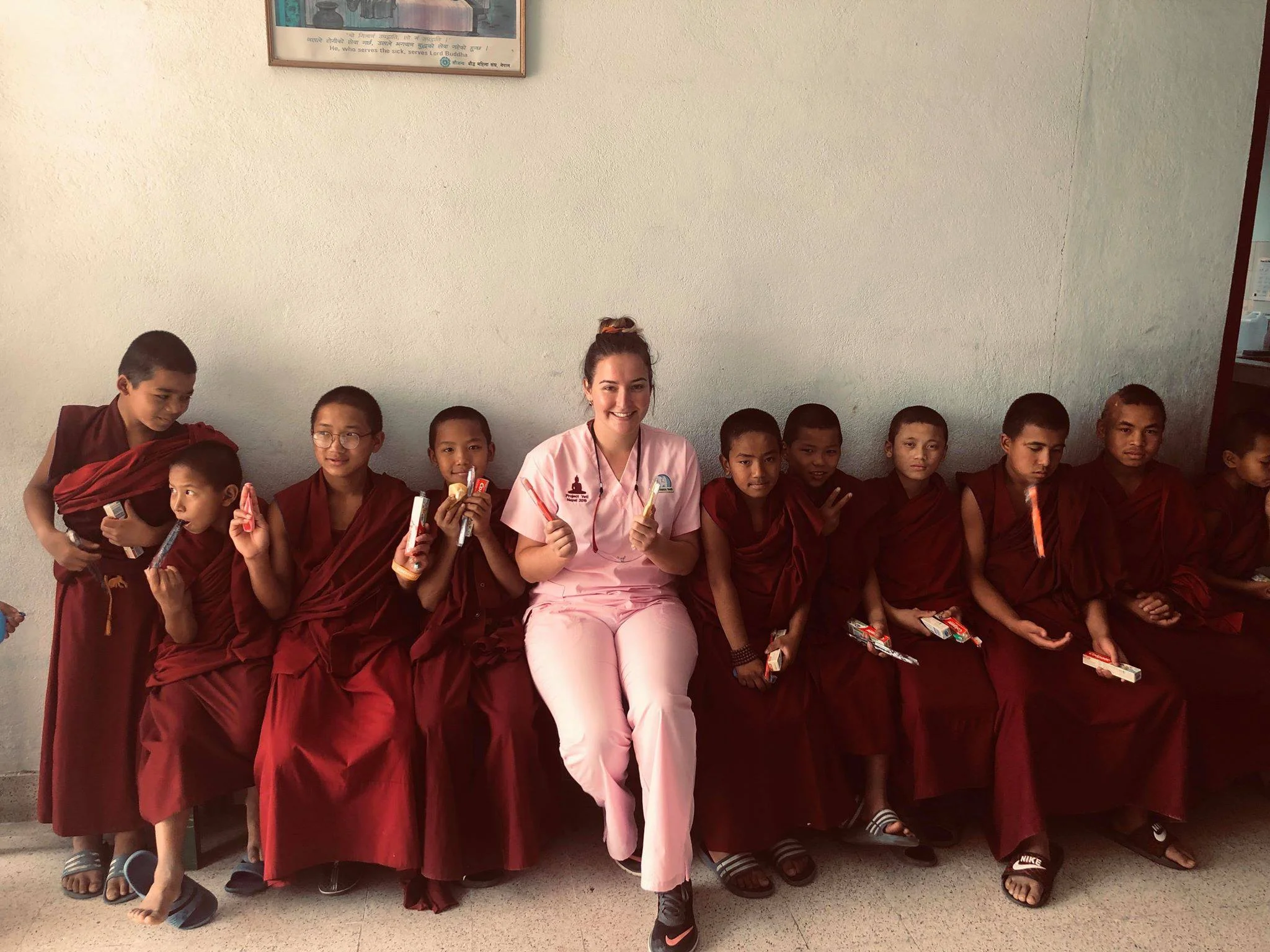 Dental Assistant Sam with Monks in the Clinic at Kopan Monastery 2019.