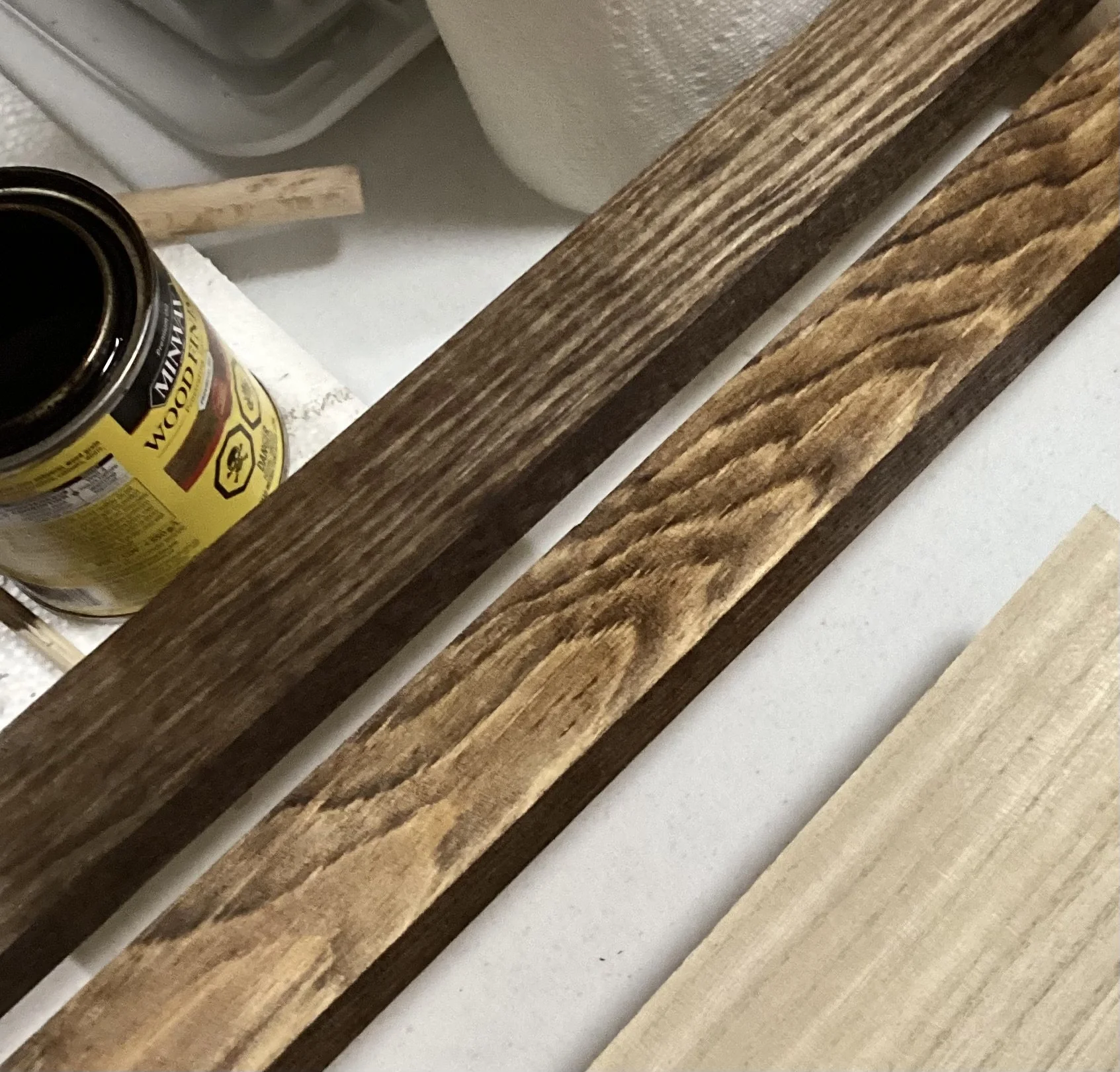 pot of open wood stain lumber with stain on it