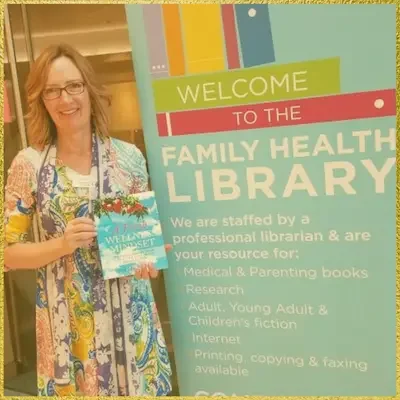 Tam John with her book ‘A Fresh Wellness Mindset’ at the UC Children’s Hospital Family Health Library.