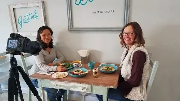 Tam John filming nutritional podcast with Dr. Rachel Yan at Just Be Kitchen in Denver, CO