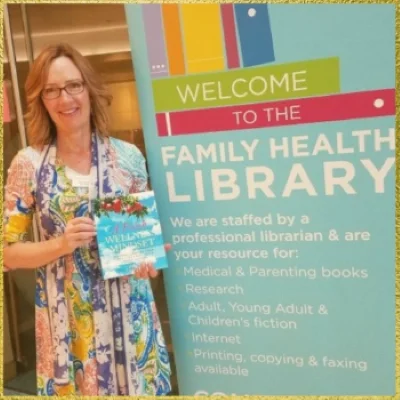 Author Tam John with her book "A Fresh Wellness Mindset: Personalize Your Food Life and Find Your Truth about Gluten" featured at the Family Health Library at Children's Hospital Colorado.