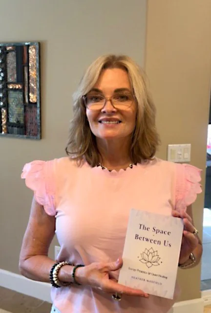 Heather holding a copy of her new book
