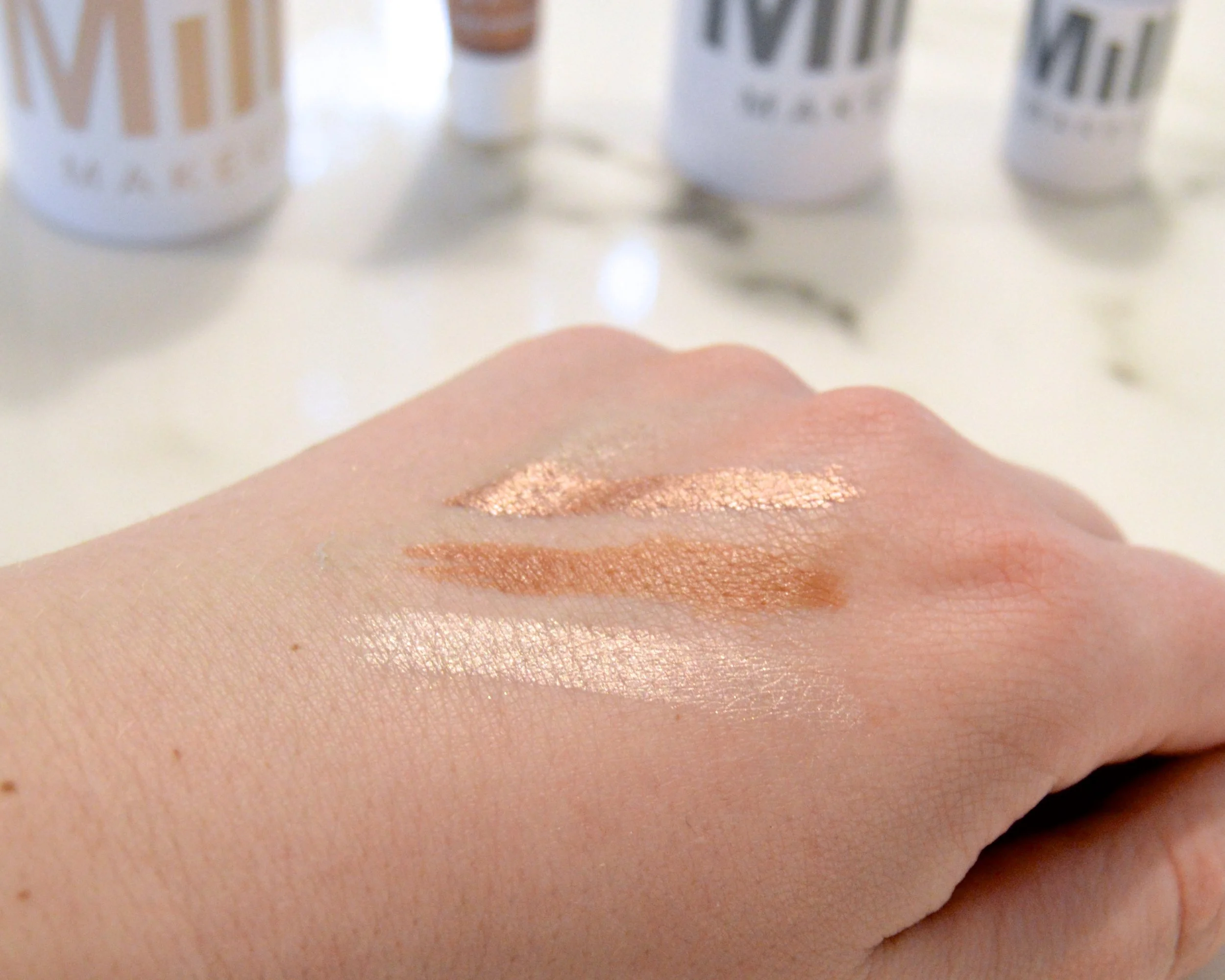 (Top down): Eye Pigment in Gig, Bronzer in Baked, and Highlighter in Turnt
