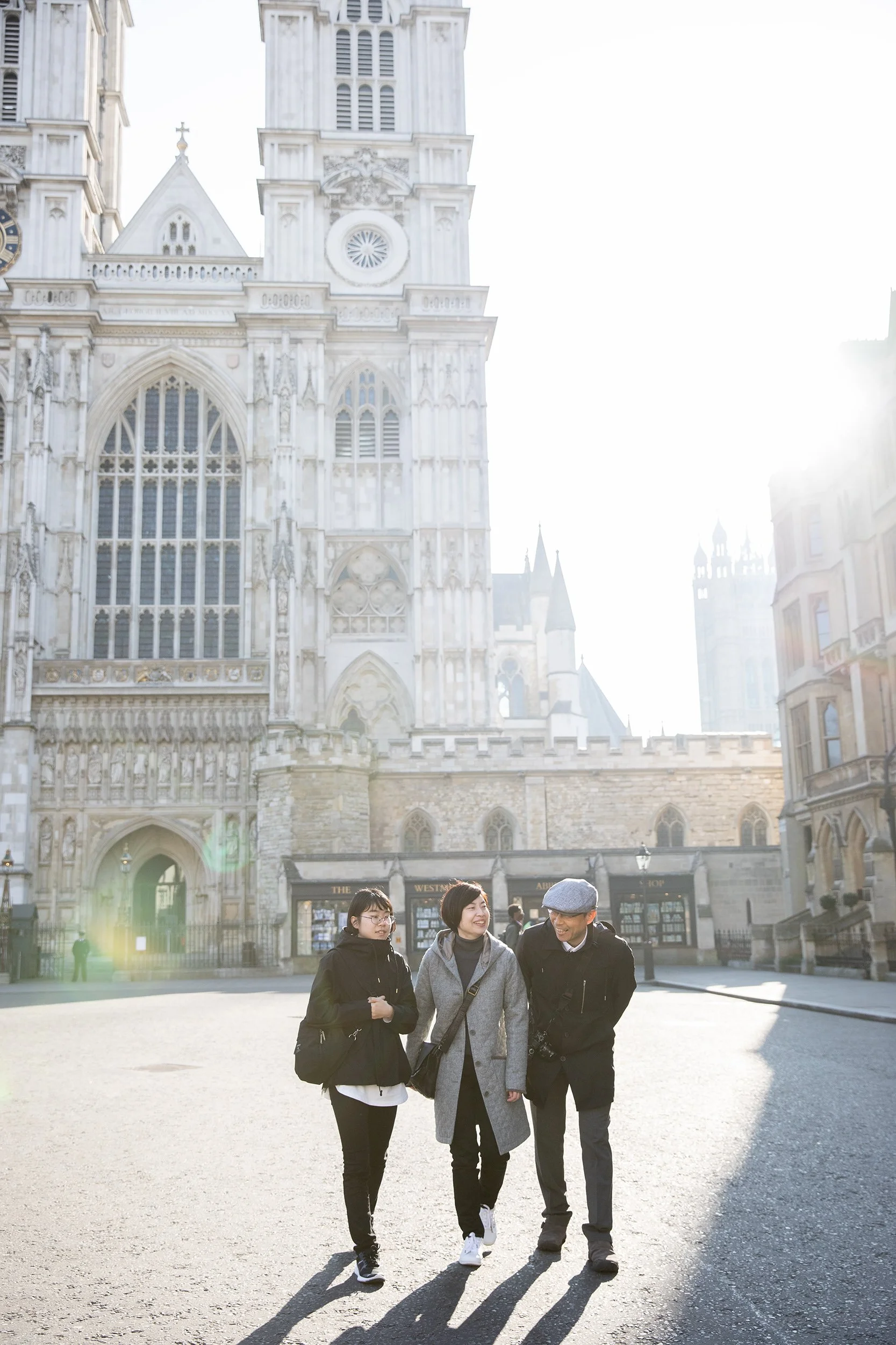 a family sharing laughter in front of Westminster Abbey