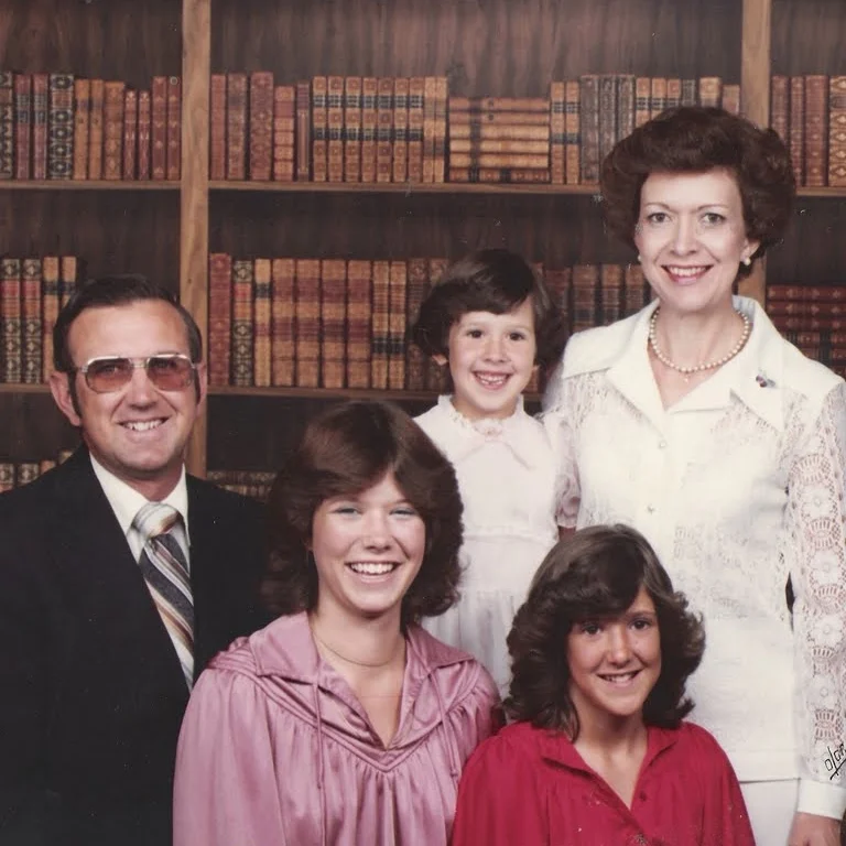 olan mills, 1979. I am the youngest of three girls. A few things I need to clarify. Yes--we were incredibly wealthy as demonstrated by the library of leather bound books. No--my dad did not forget to take off his sunglasses. they looked like that 24 hours a day. no--my sisters were not extras on the set of saturday night fever but my sister Lauren and I did have a bee gee's staying alive poster that hung in our room.