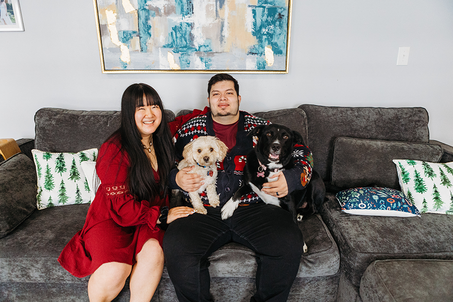 Couple sitting on couch with dogs during Christmas Photoshoot