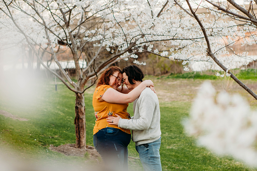Couple embracing under Cherry Blossom tree at White River State Park Photo Session