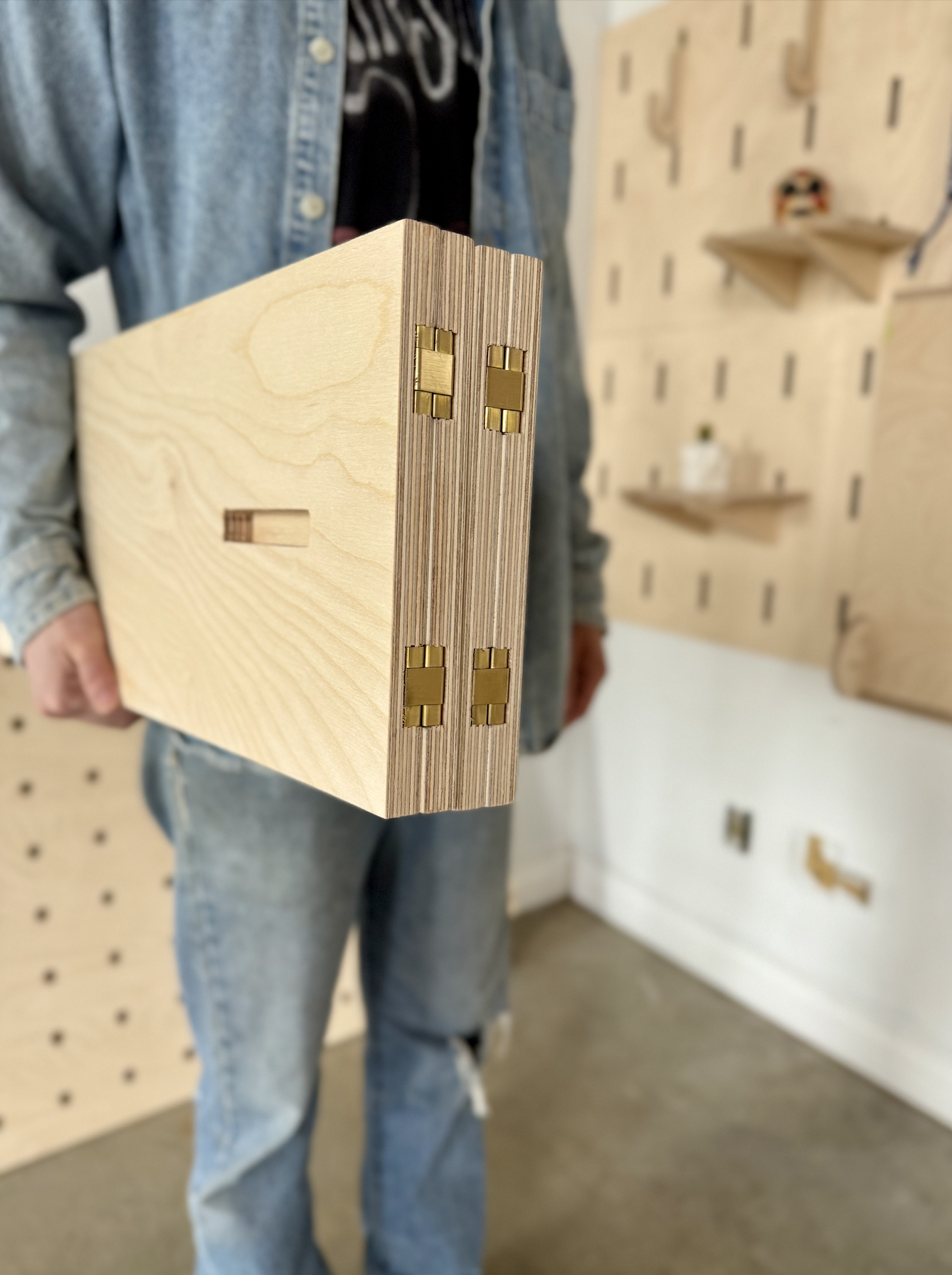 Flat pack freestanding pegboard with hinged legs.png