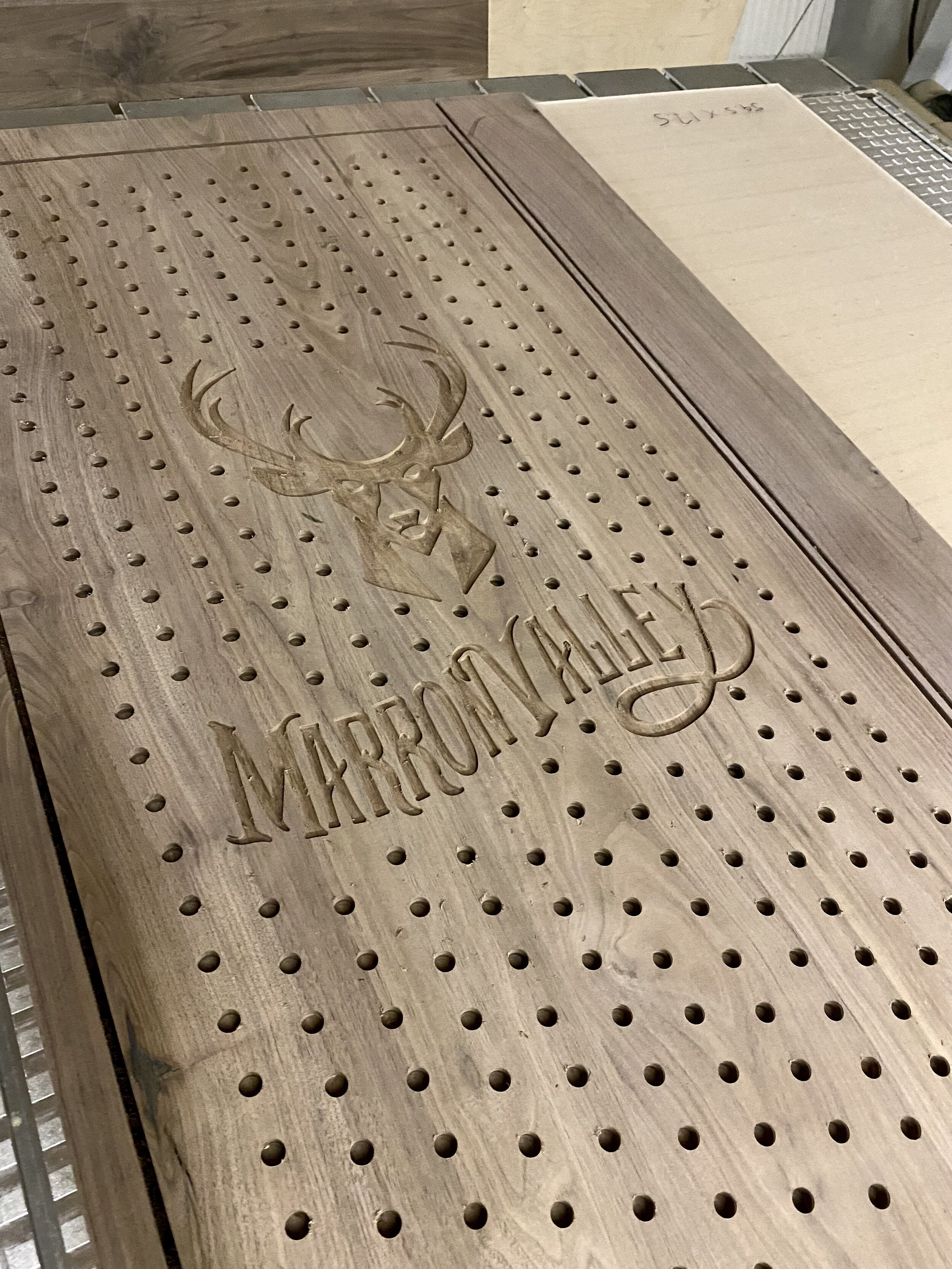  Solid walnut pegboard with custom engraving freshly completed on the CNC 