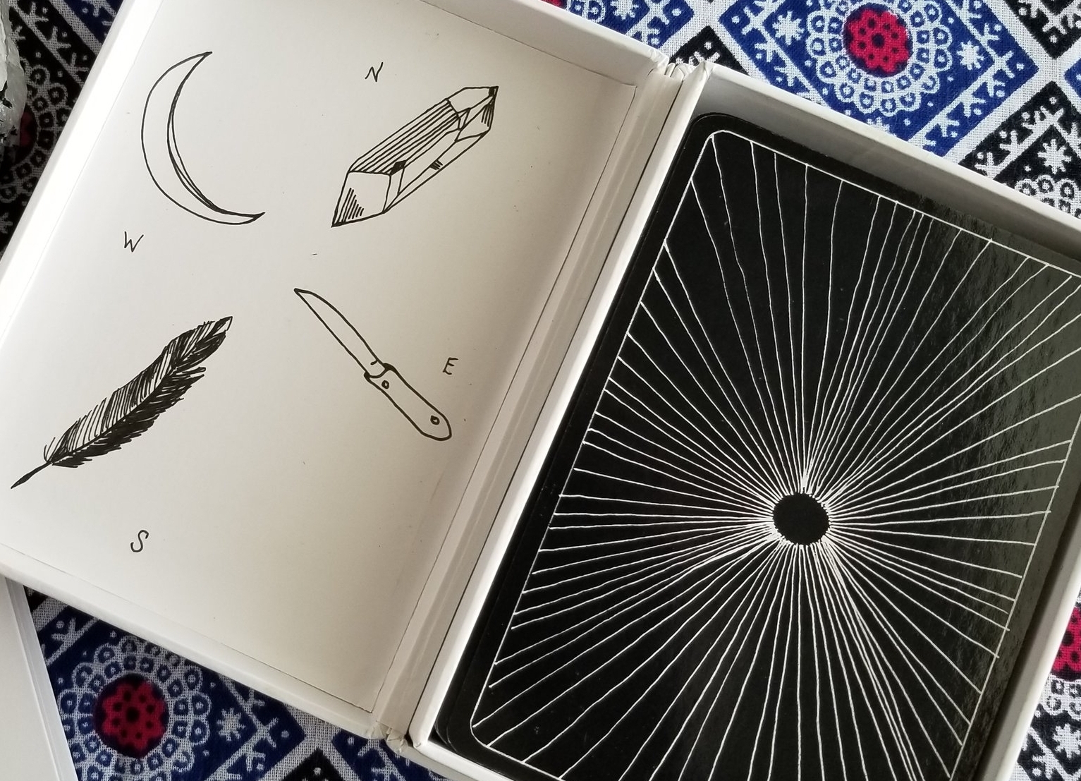 The Wanderer's Tarot box, with its very back to basics representation of the suits and the portal of Tarot