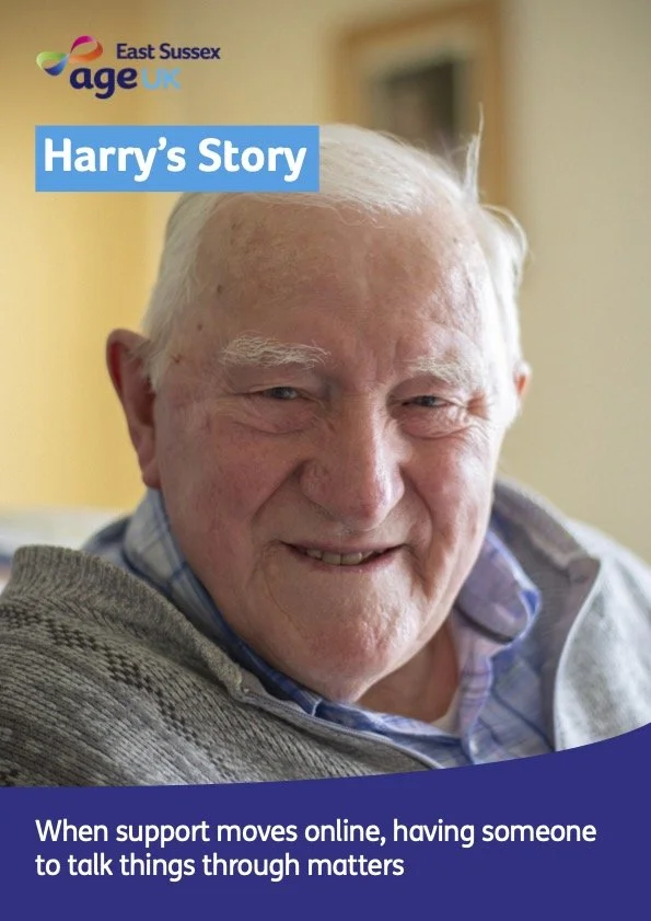 Close-up of an elderly man smiling, with a background showing a yellow wall and a window. The image includes the text "East Sussex age UK" at the top left, a blue banner reading "Harry's Story," and a caption at the bottom: "When support moves online, having someone to talk things through matters."