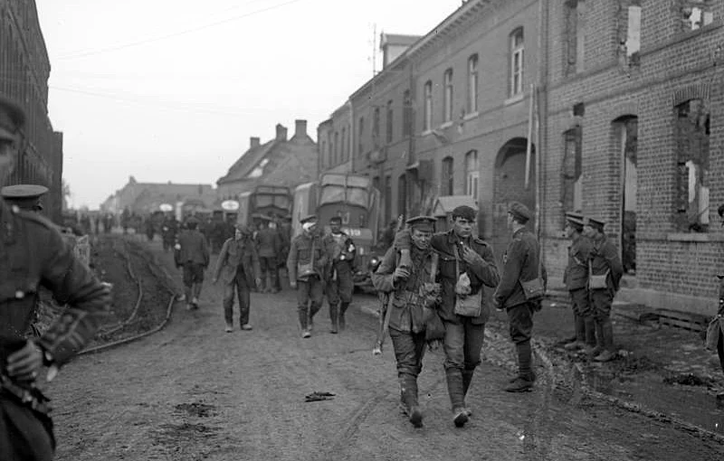 Wounded British troops returning through Vermelles after the attack on Hohenzollern Redoubt, 13th October 1915.