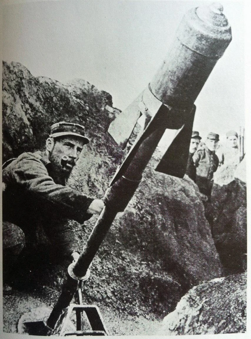A French soldier firing an aerial torpedo shell from the trenches.