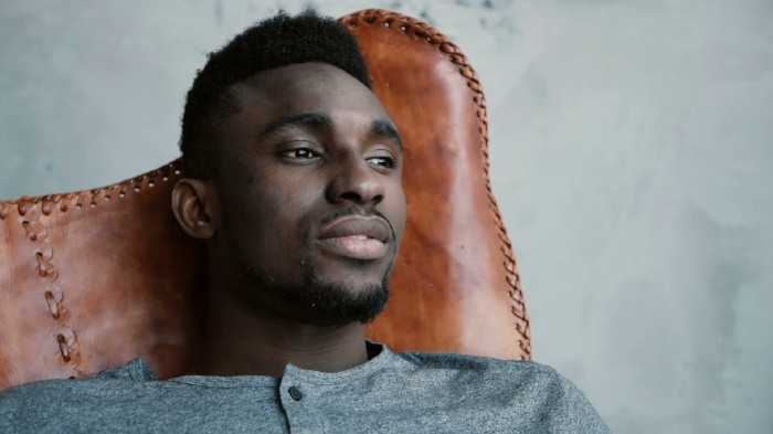 videoblocks-a-young-african-male-sitting-in-the-chair-looking-into-the-distance-and-thinking-about-something-man-looks-thoughtful_rolr2itae_thumbnail-full01.png