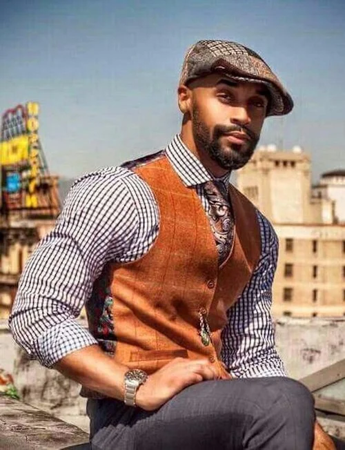 The Look: Fall Into Optimism this Moment! Brown Donegal-Style waistcoat ($37) by Lloyd Attree & Smith; Brown Wool Herringbone British Design Button Top Cap ($19.99) by Gamble & Gunn Shelby.