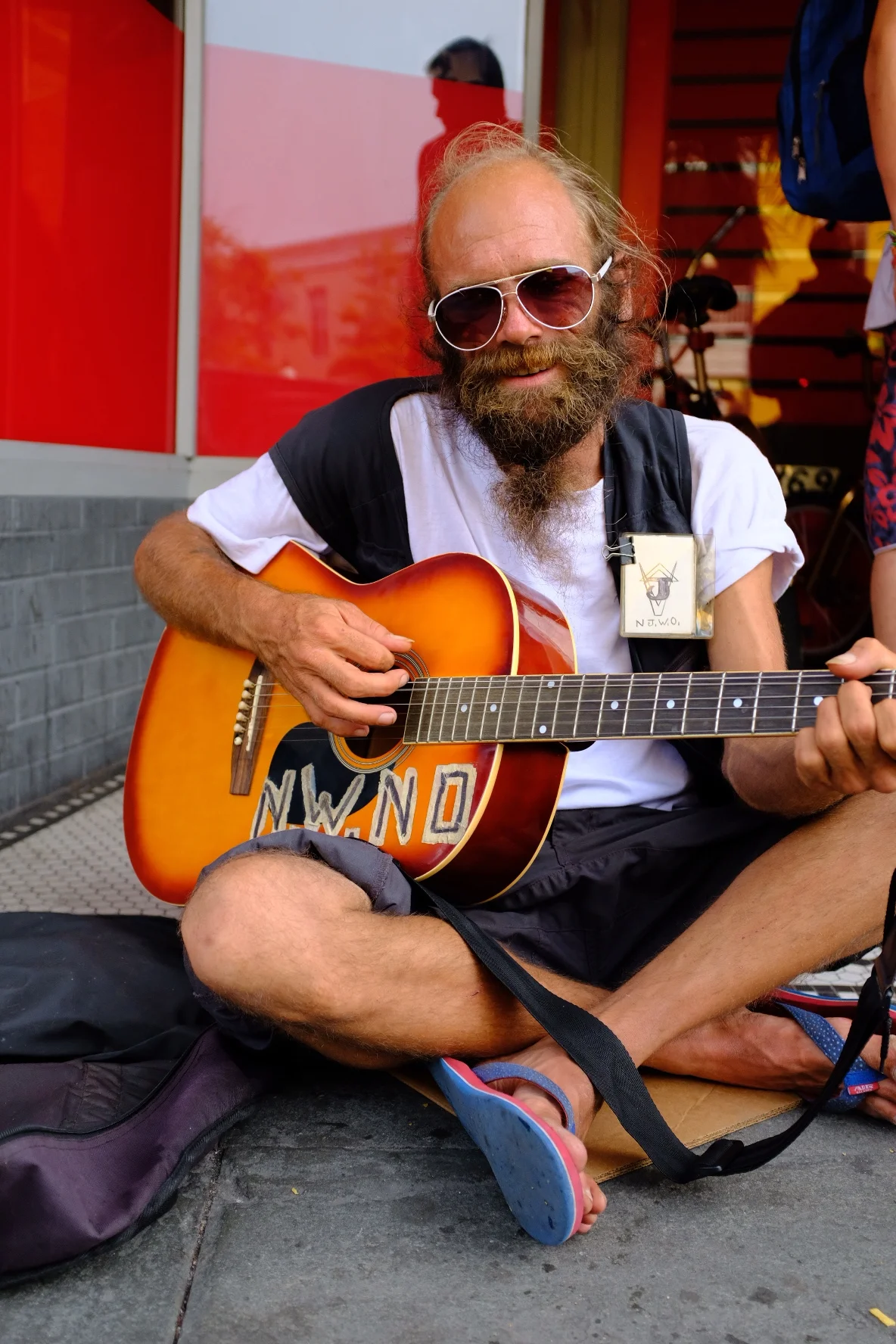 MAN WITH GUITAR RED WALL.JPG
