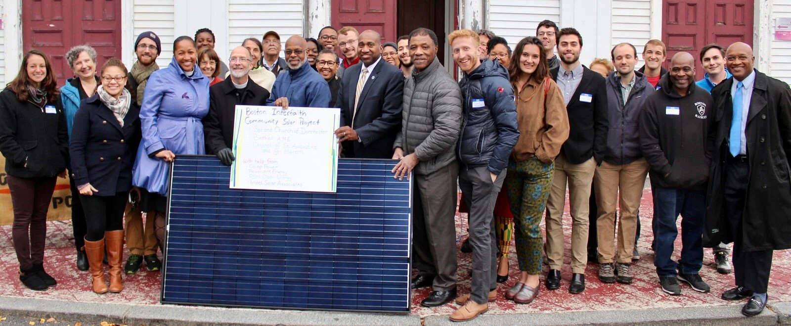 Community members and stakeholders gather at the Second Church in Dorchester to celebrate the Interfaith Solar Project. Through the project, Boston Impact Initiative supported solar installations on the rooftops of three Boston churches in majority non-white neighborhoods.