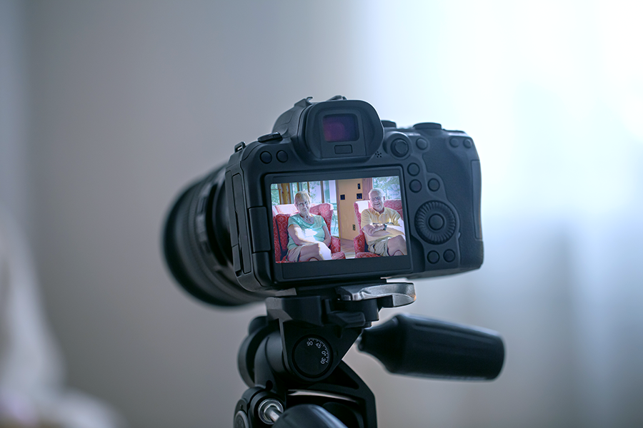 A video camera screen showing a couple being interviewed