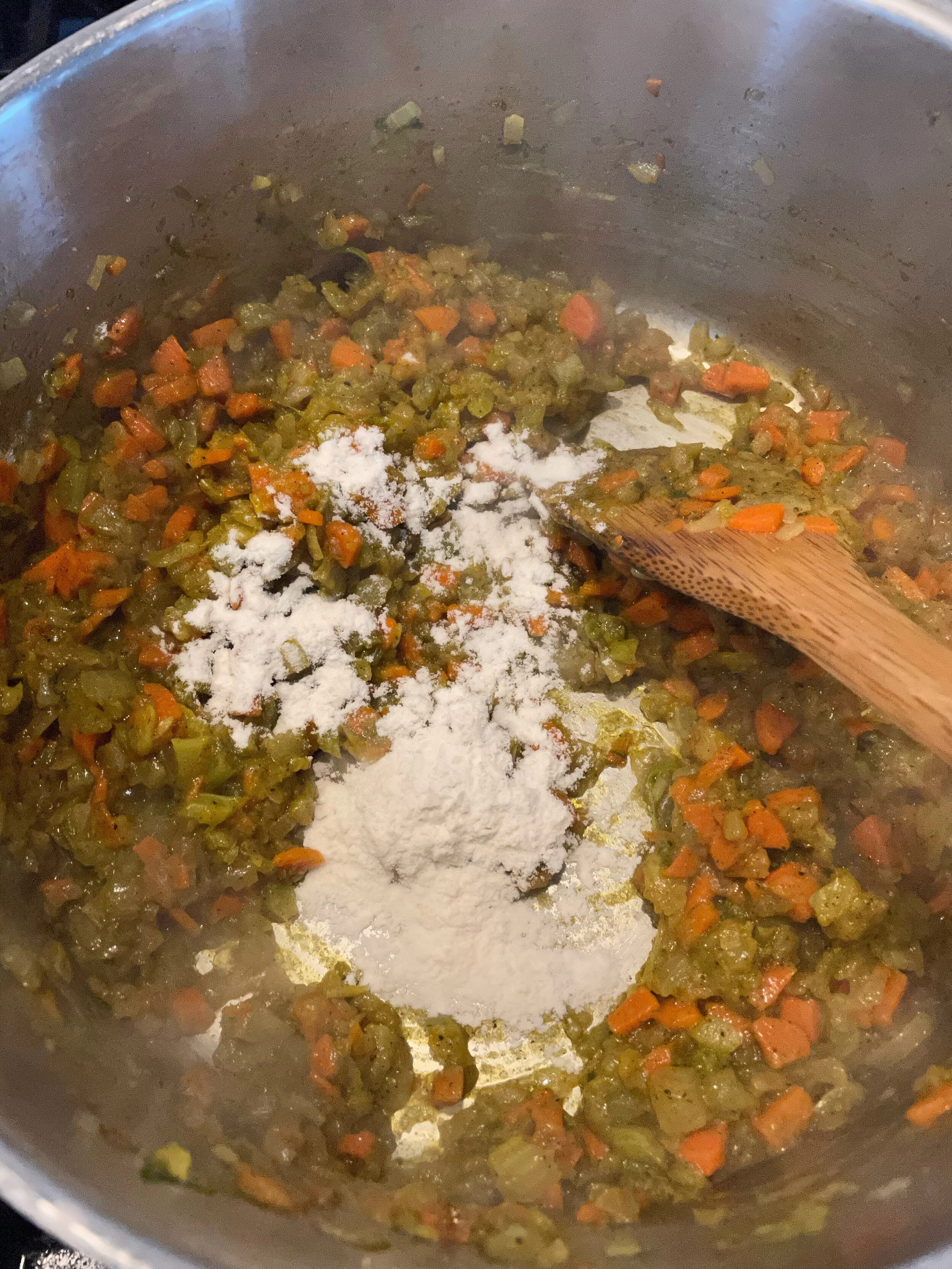 Stirring in flour to veggies and spices