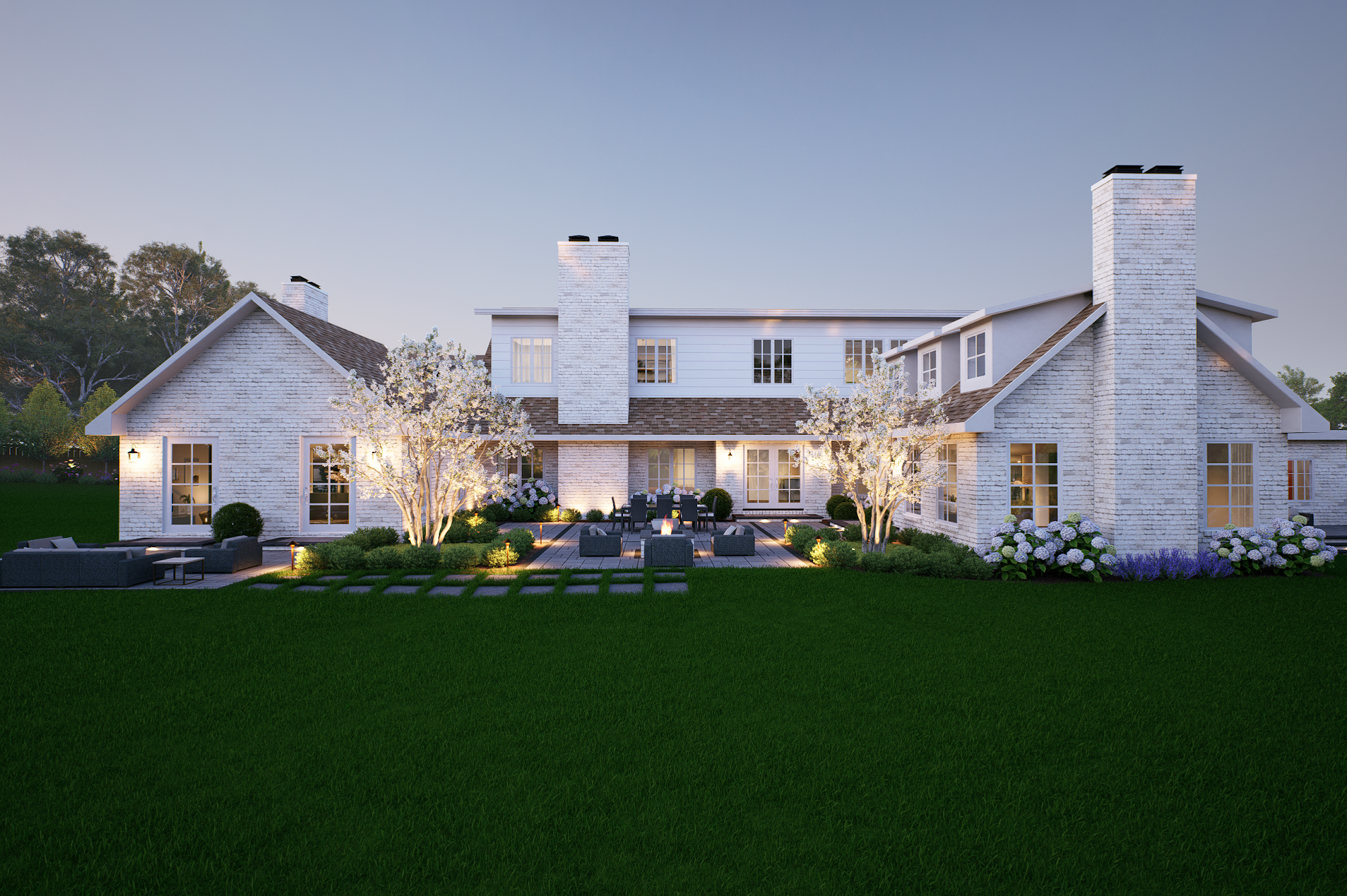 A modern suburban backyard with a white brick house, illuminated outdoor patio, blooming trees, and well-maintained green lawn at dusk.