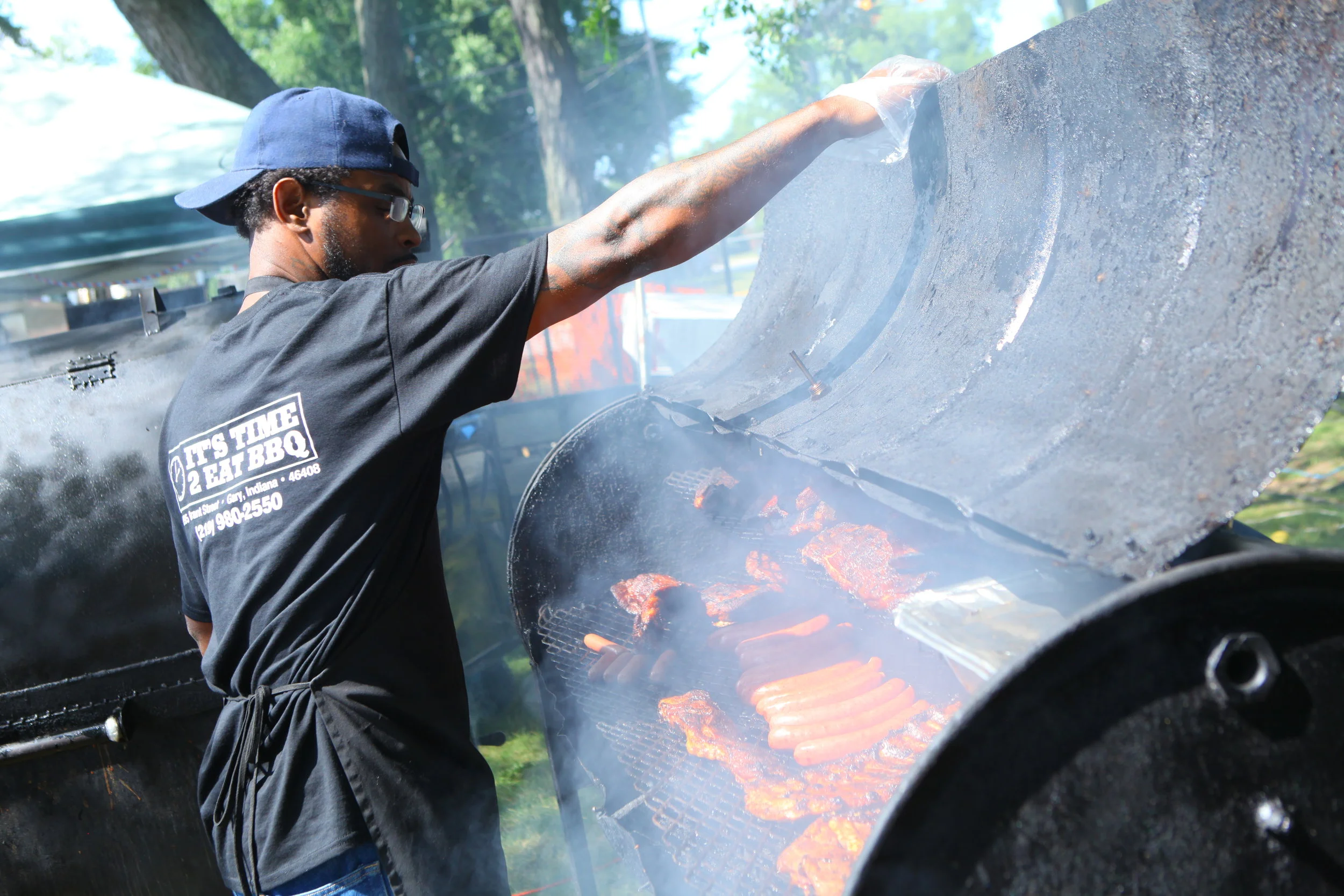 William Campbell, of Gary, checks on barbecue meats in a smoker belonging to It's Time 2 Eat BBQ at the Broad Street Blues Fest in Griffith on July 1, 2017.