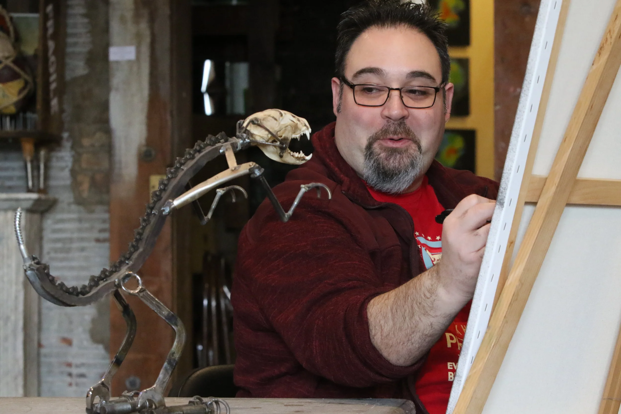Chris Guzman, a curator at Paul Henry's Art Gallery in Hammond, Indiana, smiles as he translates the likeness of "Two Cent Cindy" onto a canvas.