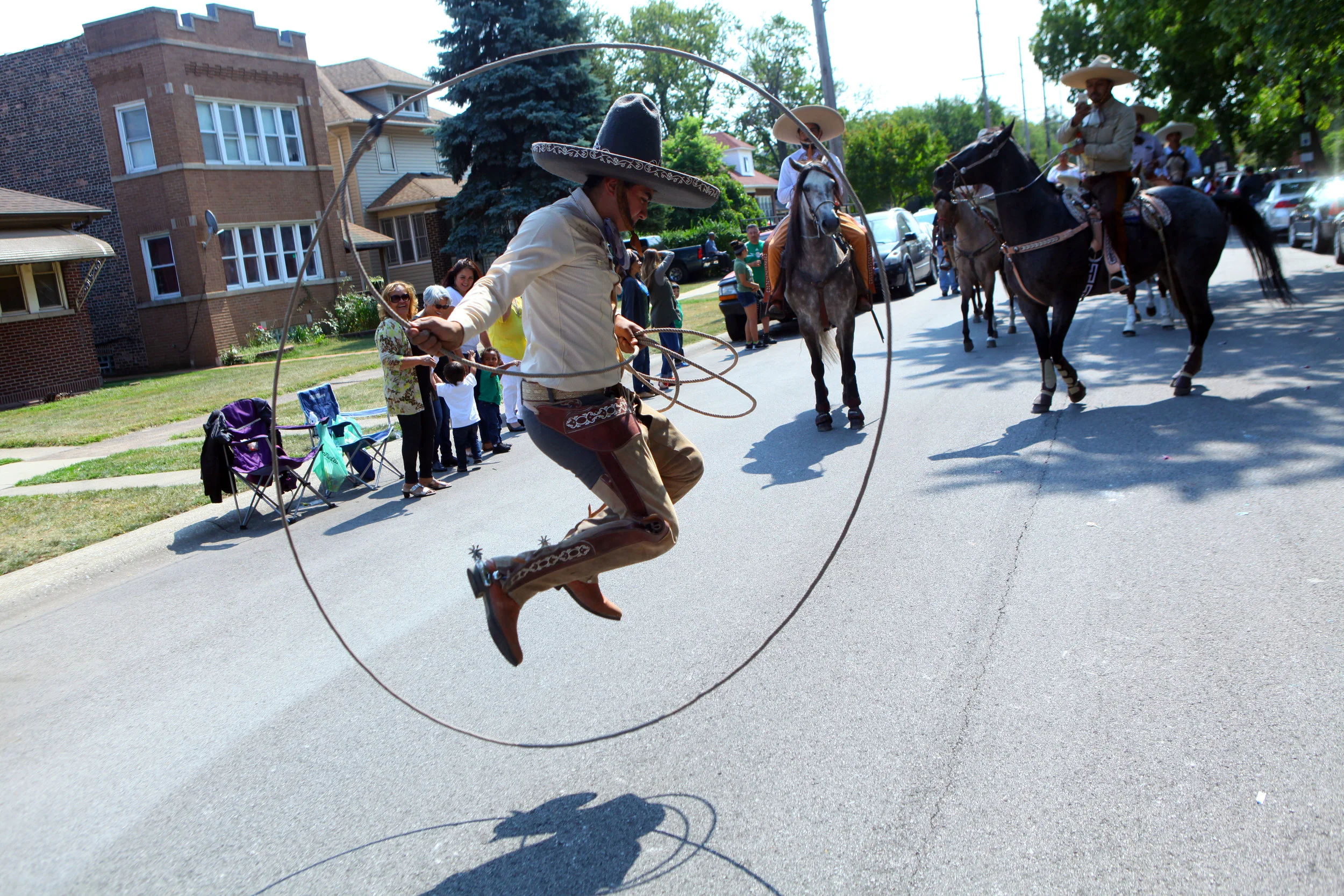 Lasso tricks are performed on Parrish Avenue during the Mexican Independence Day Parade in East Chicago, Indiana.