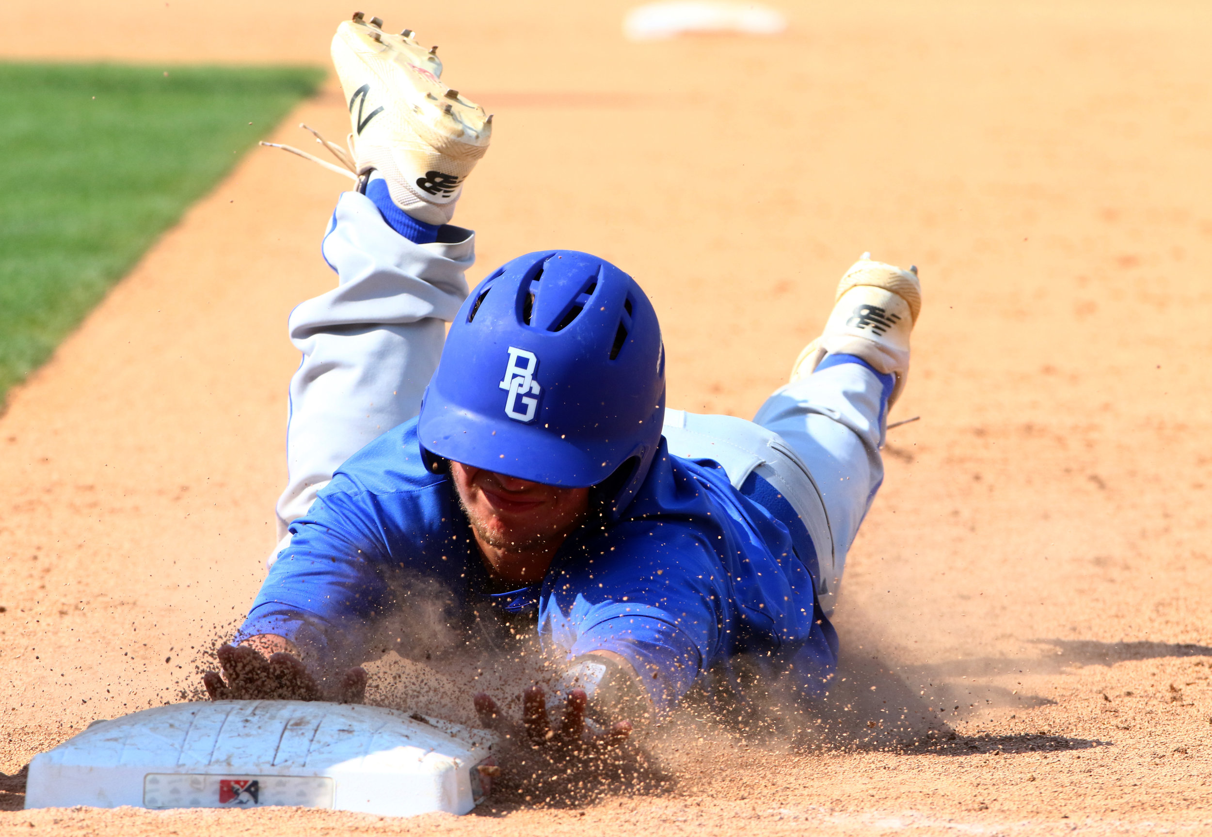 Boone Grove's Dylan Paul dives back to first to avoid the pickoff in the Class 2A state championship game against Southridge at Victory Field in Indianapolis.