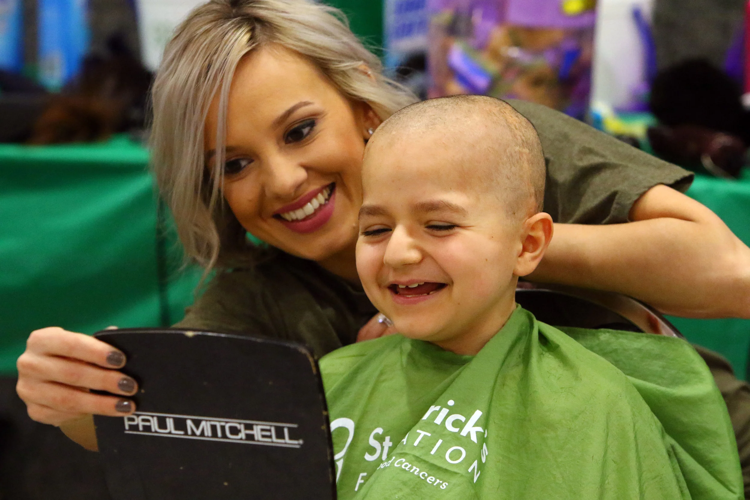 Michael Fogus, of Merrillville, checks out his reflection in the mirror after having his head shaved at the Northwest Indiana Cancer Kids Foundation 7th annual St. Baldrick's event on March 11, 2018 in Merrillville. Fogus is a two-time brain cancer …