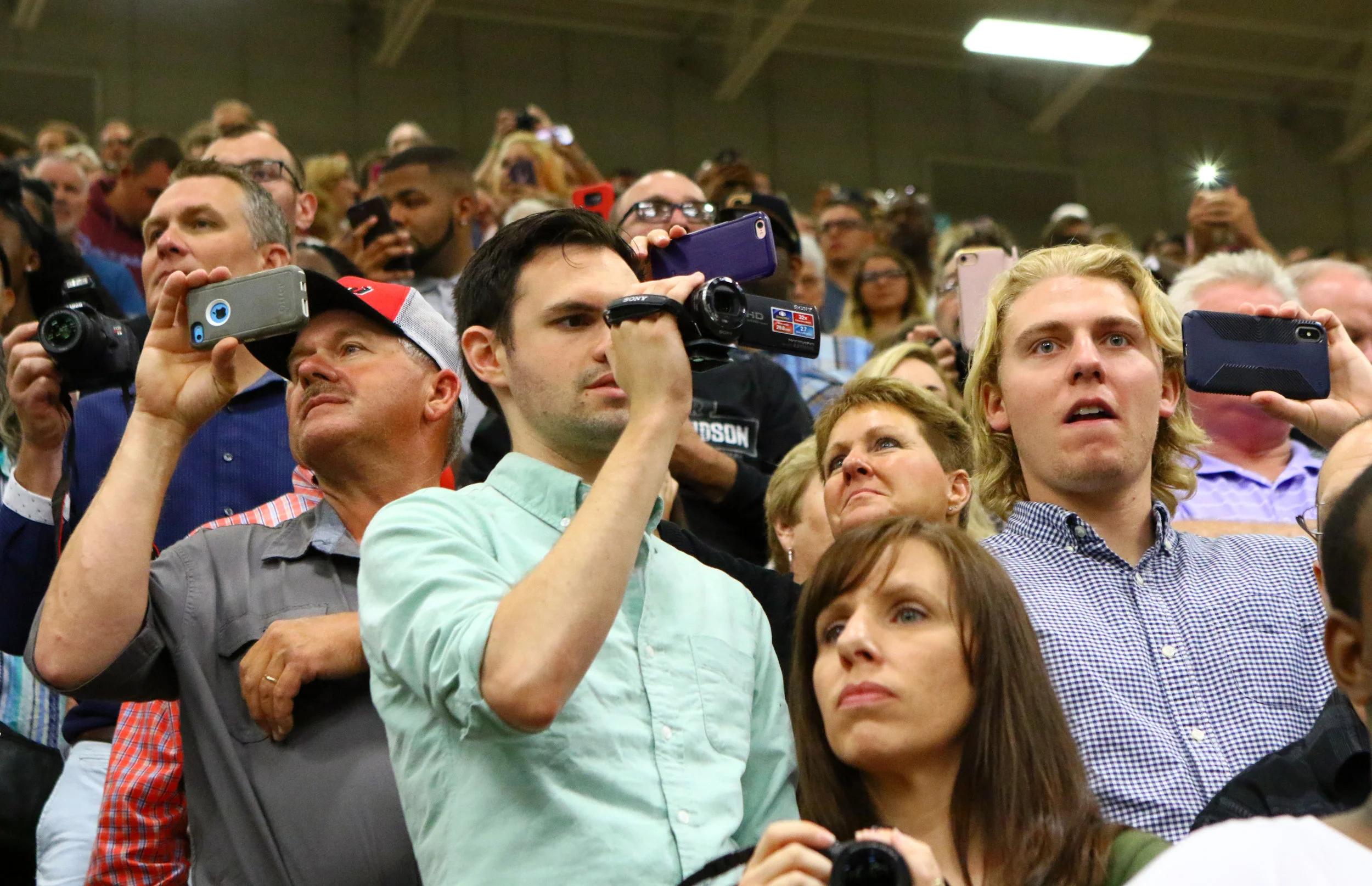 Audience members capture moments on cameras and phones on June 10, 2018 as Michigan City High School graduates proceed into the gymnasium.