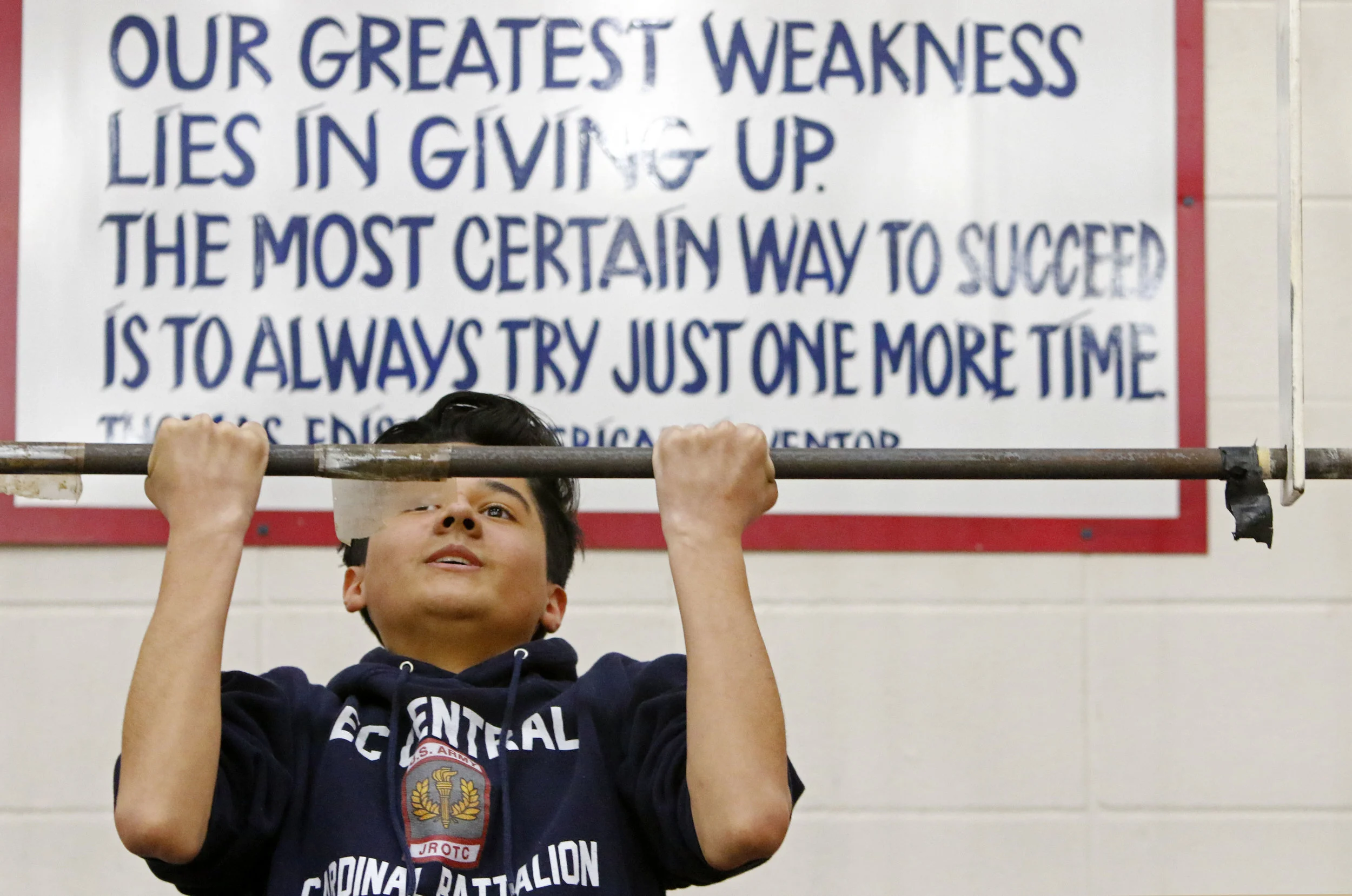 Diego Padilla performs pull-ups during his JROTC period at East Chicago Central High School. The Cardinal Battalion garnered around 80 students to help kick off the program.