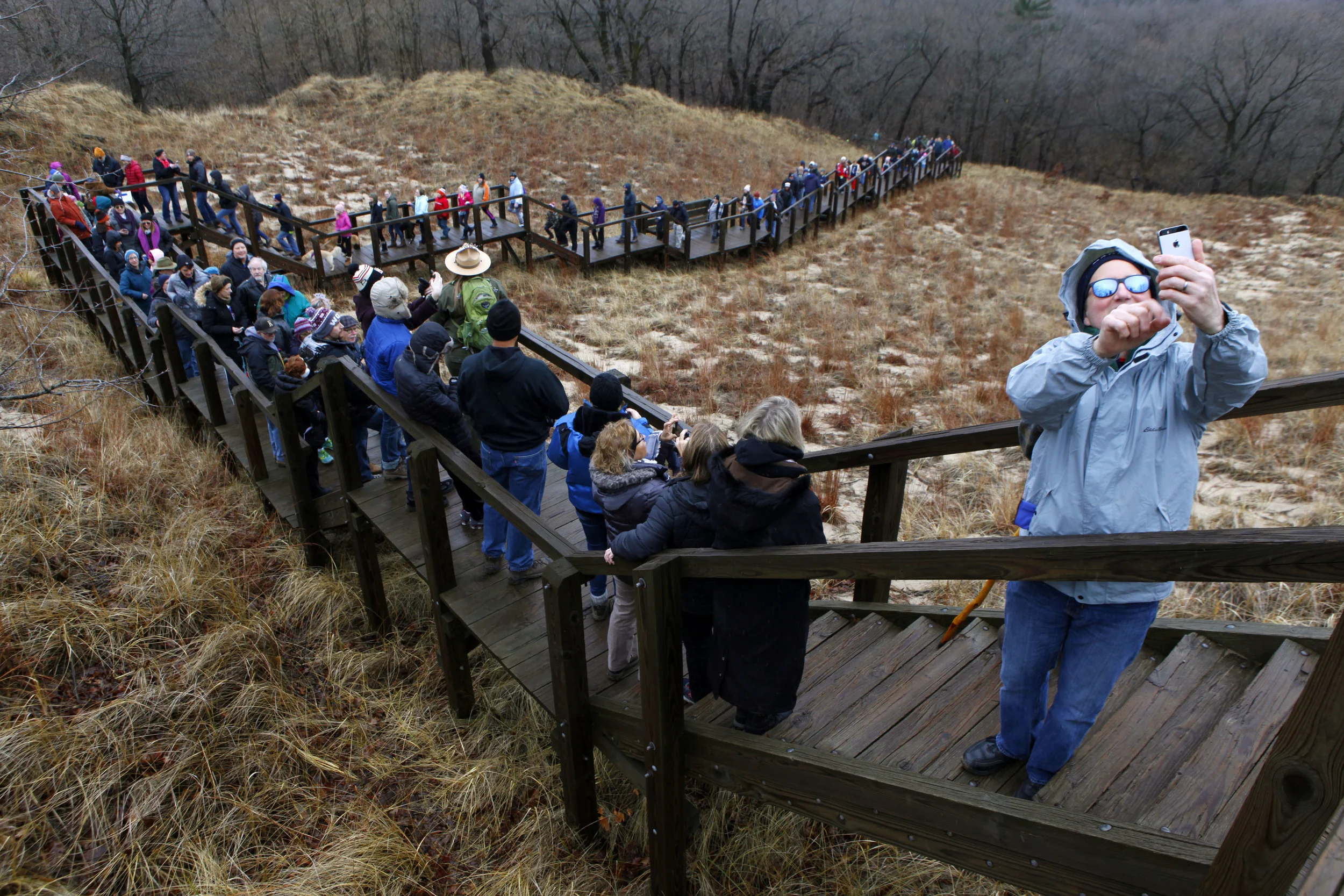 Erik Roe, right, of Highland, snaps a selfie with other visitors on the steps on Mt. Tom Tuesday during the First Day Hike hosted by the Indiana DNR on Jan. 1, 2019 at the Indiana Dunes State Park in Chesterton.