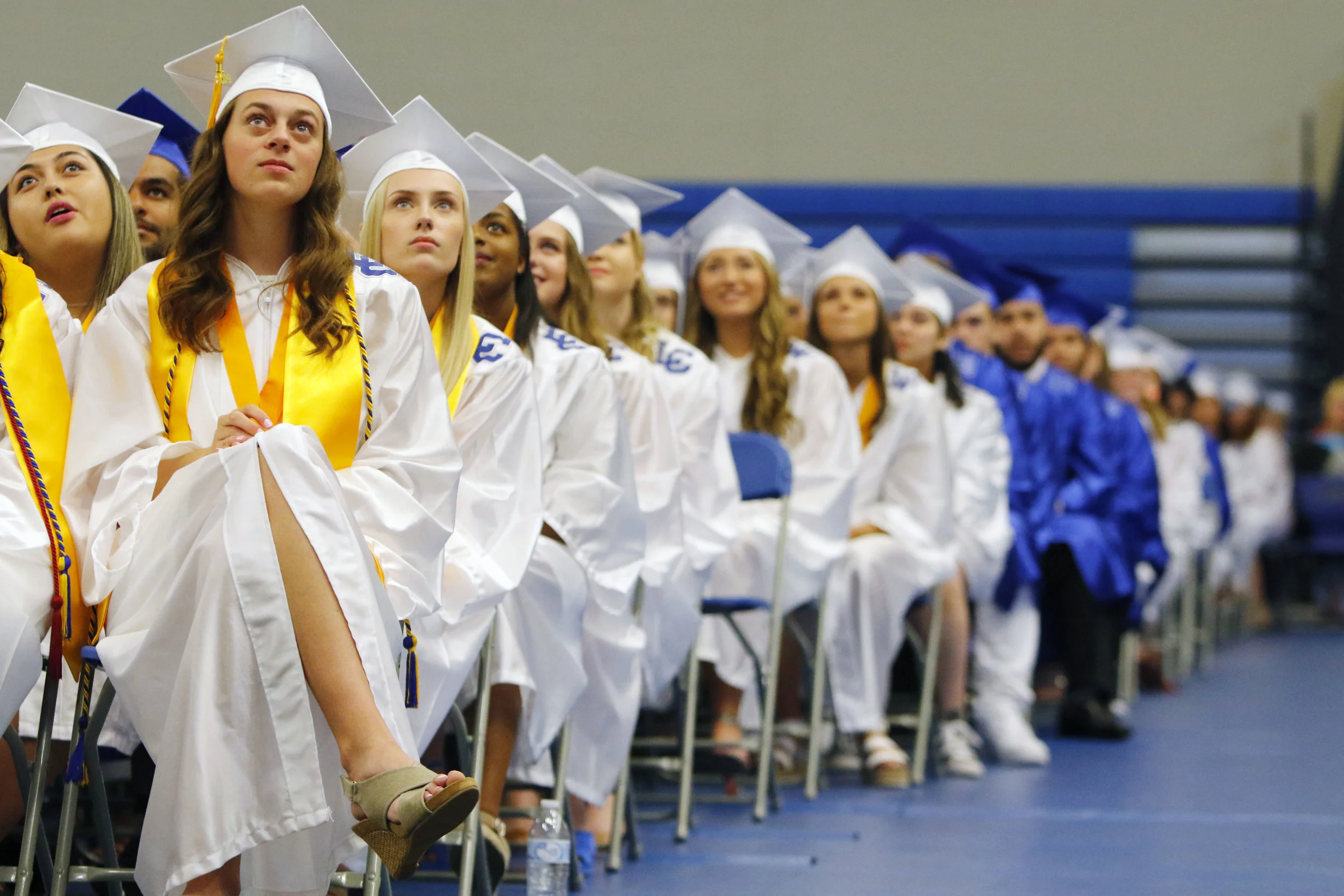 Lake Central High School graduates, including Camille Bereolos, far left, catch moments during a video tribute at commencement on June 2, 2019 in St. John.