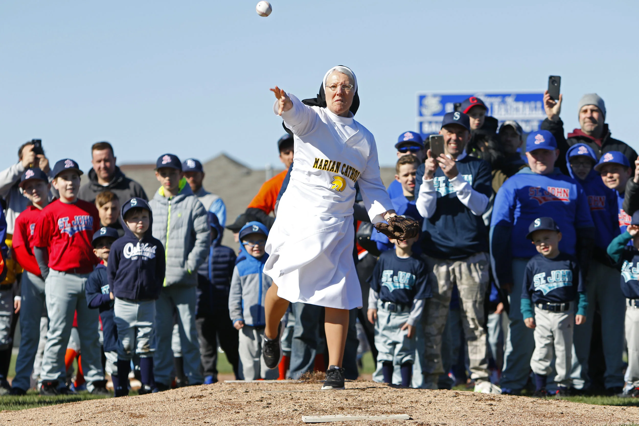 Marian Catholic's Sister Mary Jo Sobieck throws out the first pitch on April 22, 2019 during opening day ceremonies at St. John Youth Baseball's fields in Dyer. Sobieck went viral after throwing out the first pitch at a Chicago White Sox game.