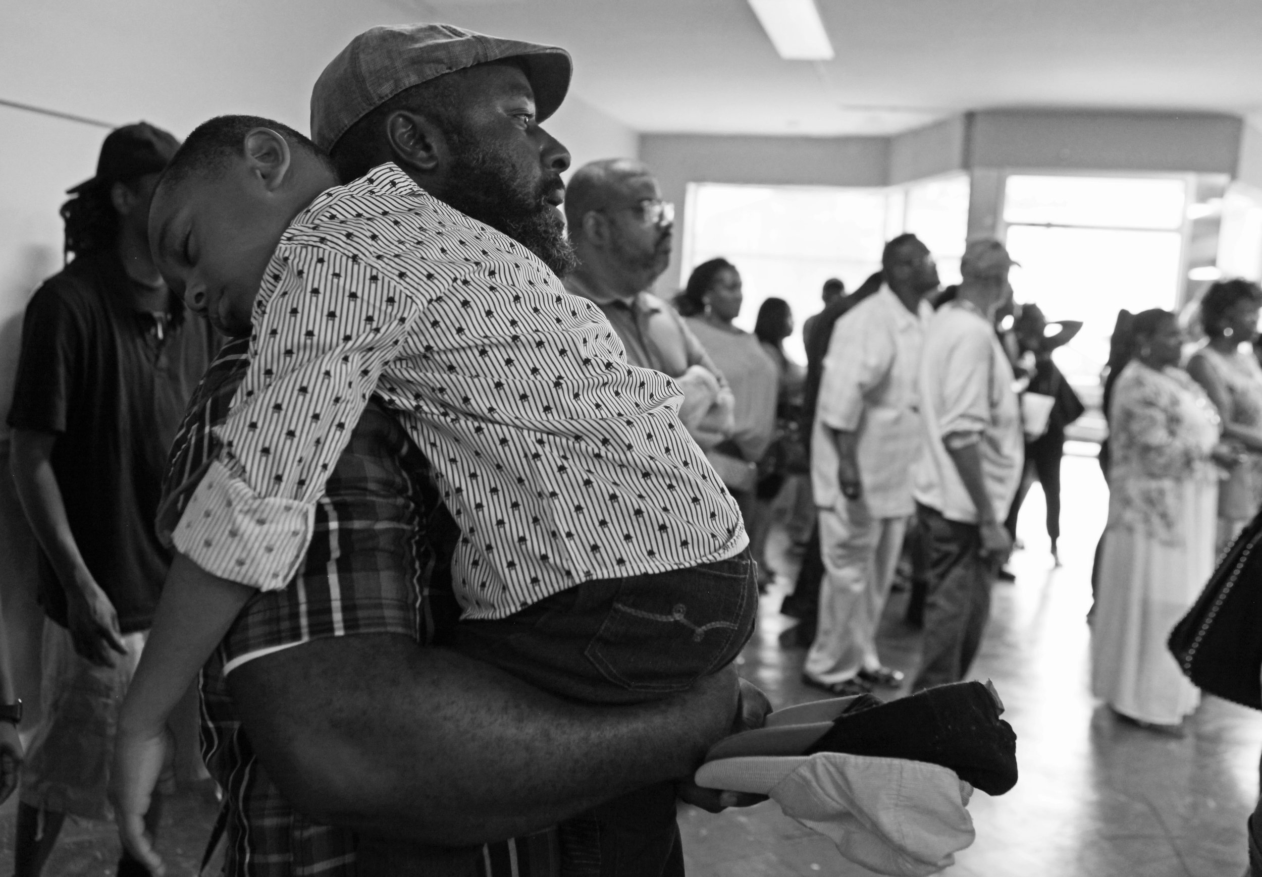 Ivan Ursery, of Gary, holds his sleeping son, Ivan III, during a “Can We Talk?” community outreach meeting hosted by Jerome Prince at his campaign headquarters in Gary on June 28, 2019.