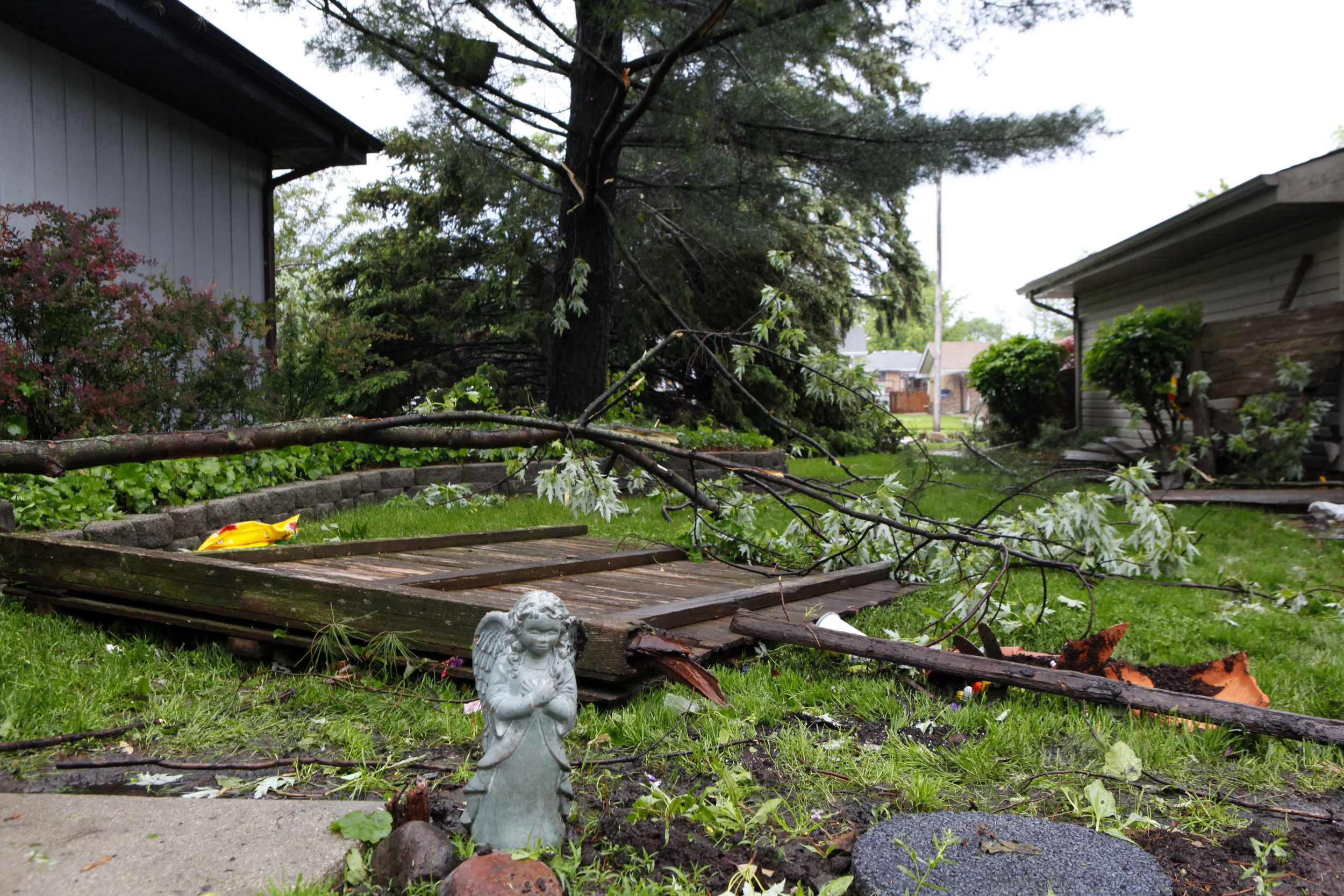 An angel lawn ornament is left standing amid damage to the home of Chris and Judy Artim caused by a tornado in Dyer on May 27, 2019.