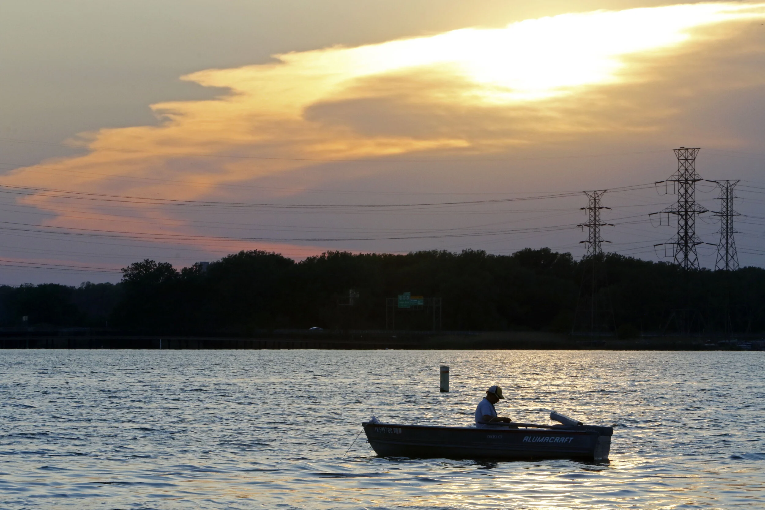 A fisher idles in the water on June 2, 2020 at Wolf Lake in Hammond.
