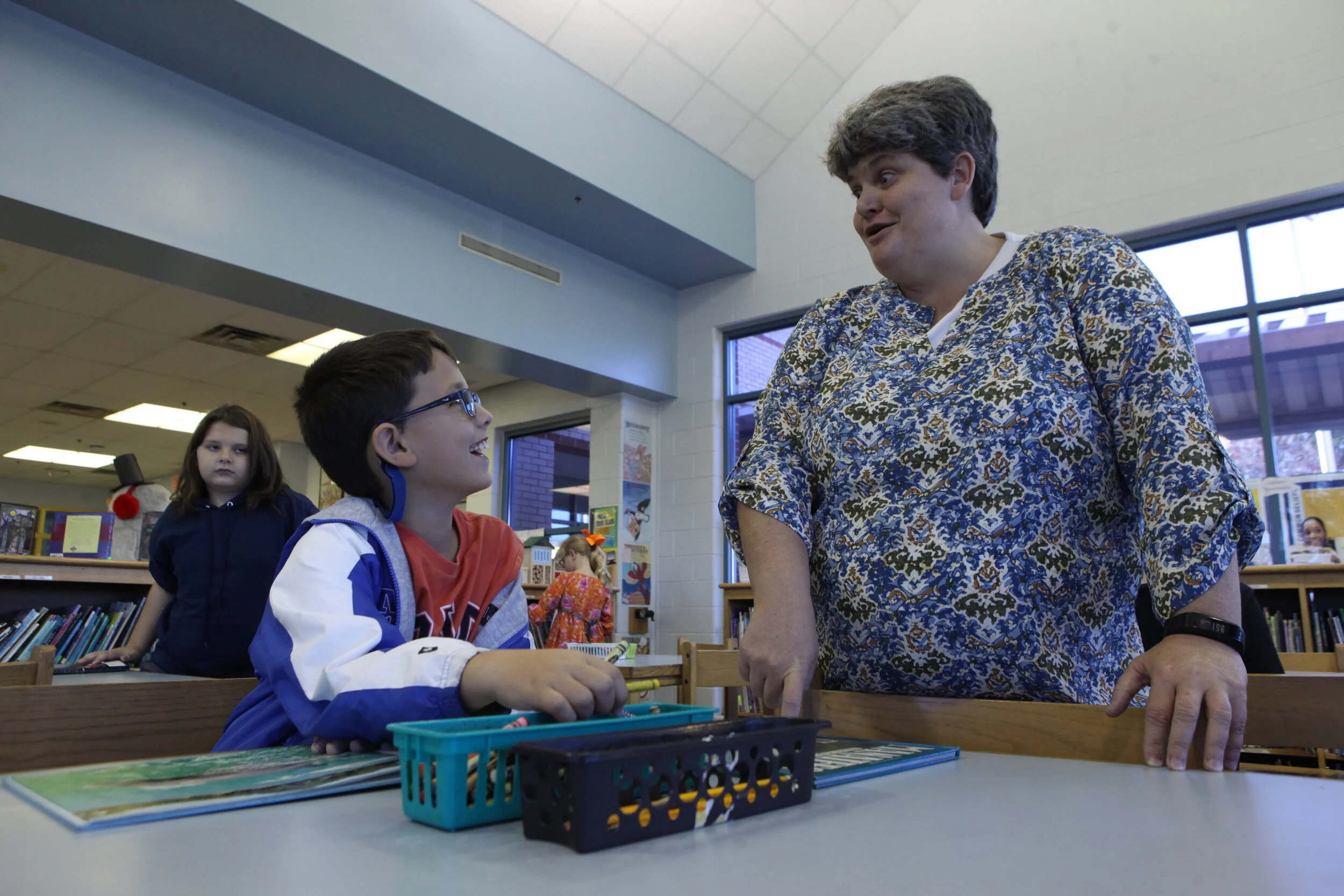 Wendy shares a moment with Brayden Myers as they talk about a book he’s reading on dolphins. 