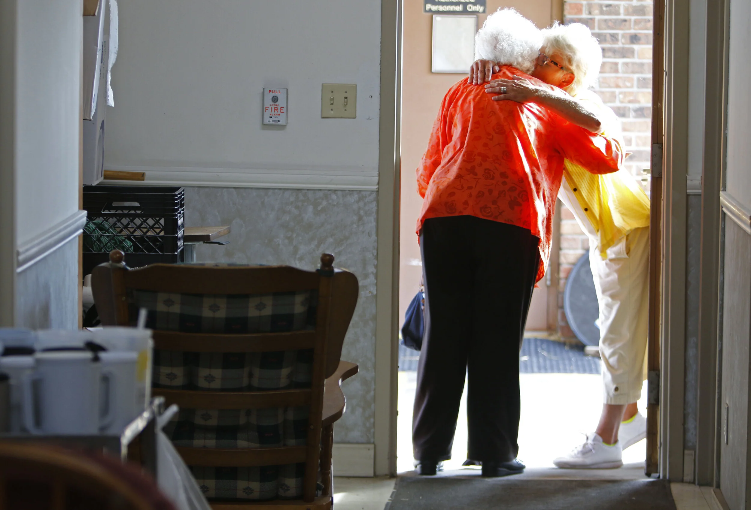  Velma Lang hugs Velma Flippin goodbye at the center. Volunteers occasionally stop in at Riverdell Care Center to assist with Lang’s activities. 