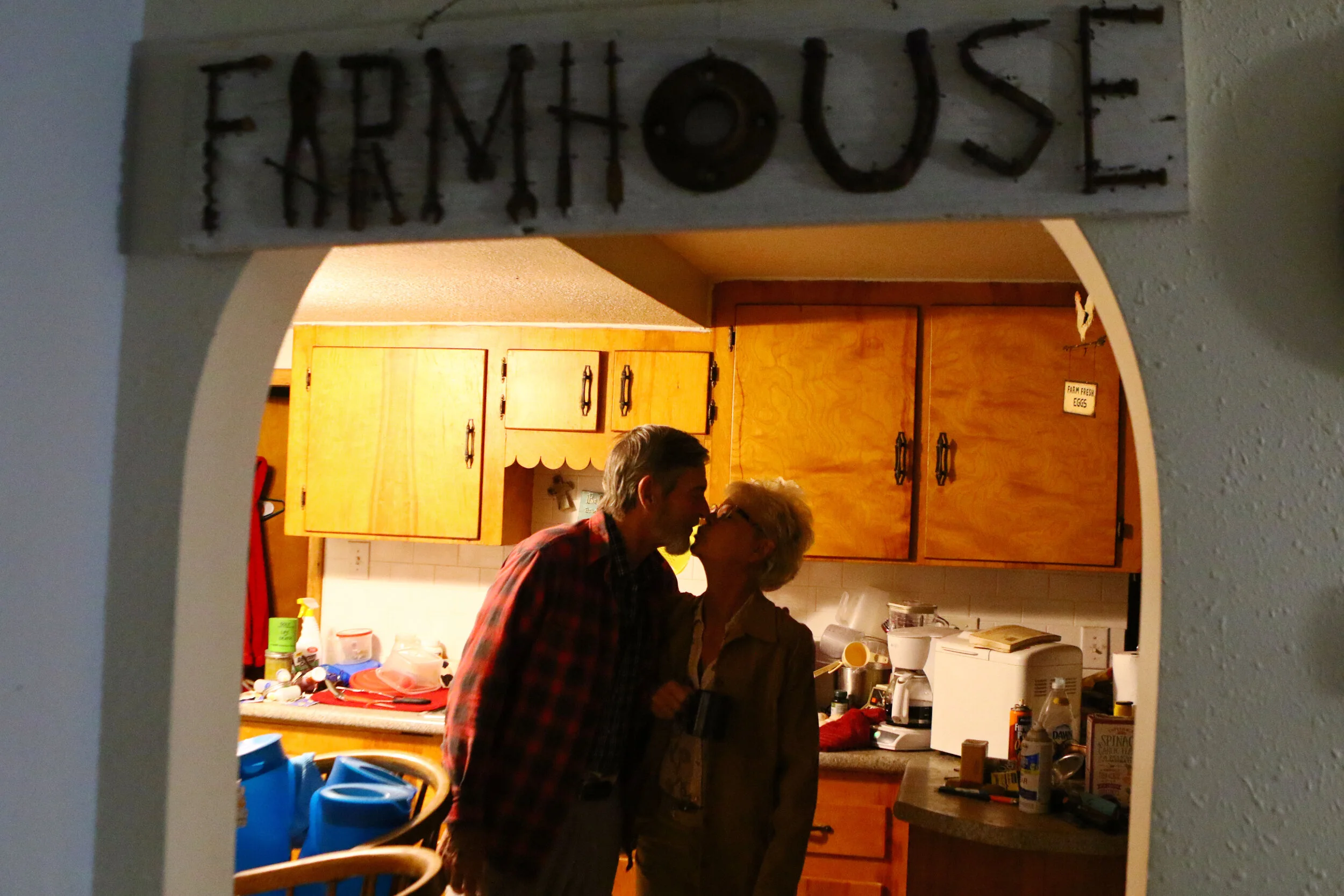  Velma Lang, right, kisses her husband, Rob Monk, goodbye in their kitchen in Syracuse before heading to work in Boonville. Lang typically wakes up at 4:30 a.m. and drives over 20 miles north to town to start work at 6:30 a.m. 
