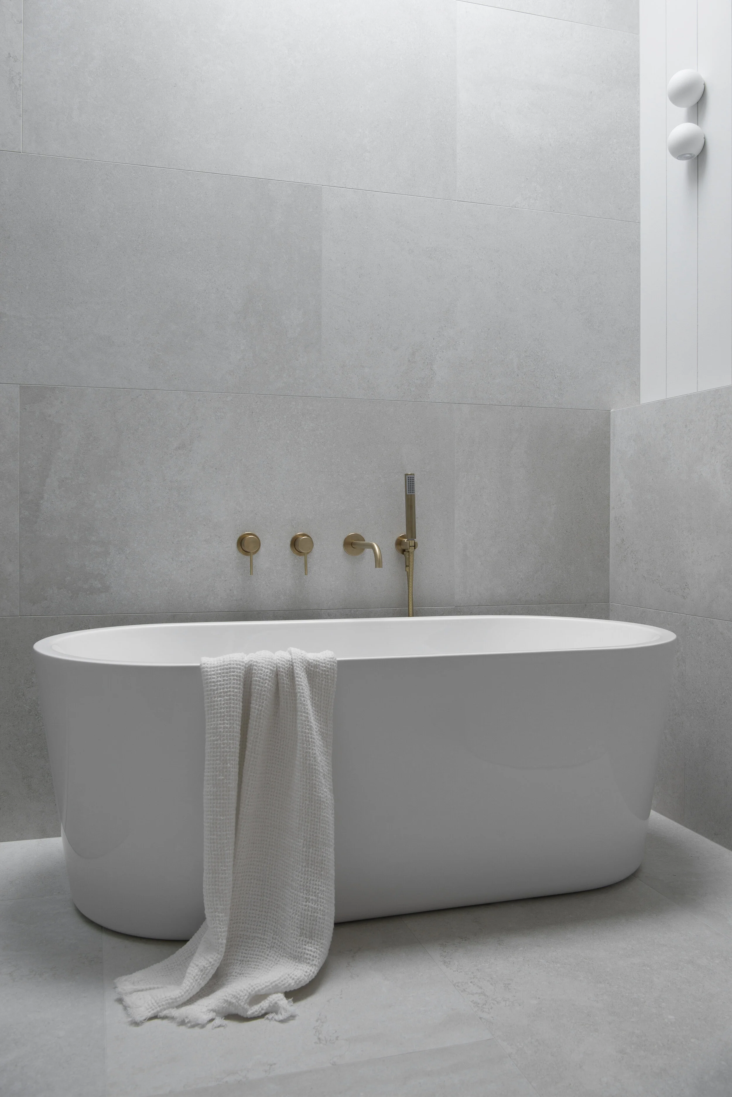 Classic Coastal Bathroom freestanding bath brass tapware with grey bathroom tiles