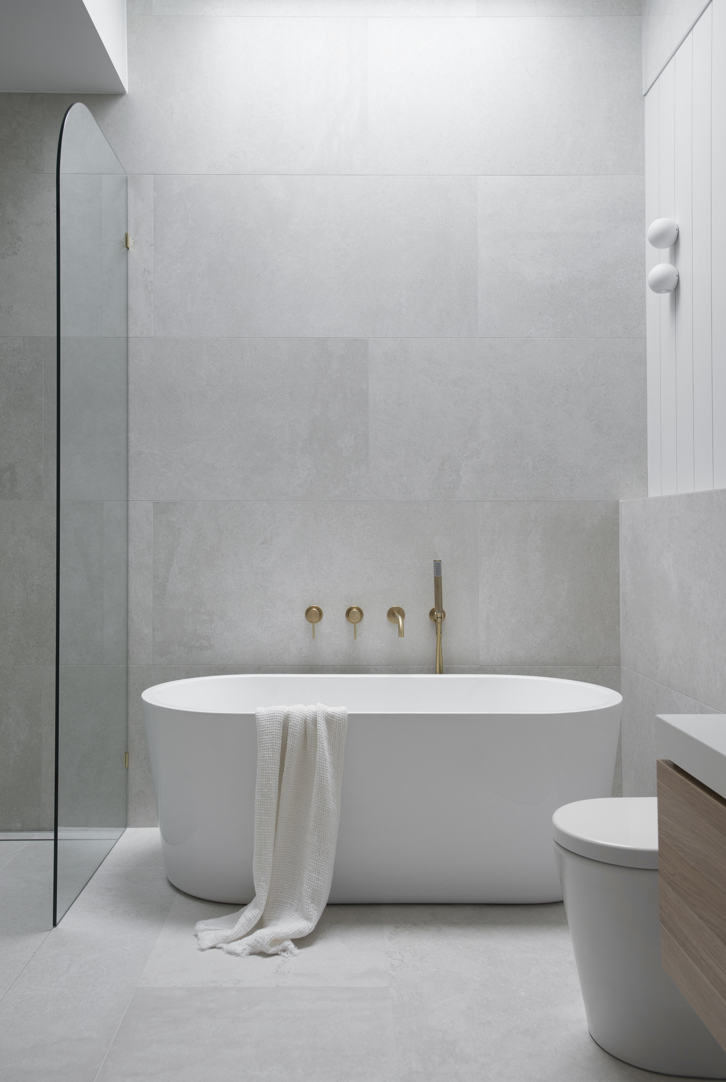 White bathtub with grey tiles in classic coastal bathroom design for the classic coastal bathroom project in the classic coastal home design bundle for home remodel