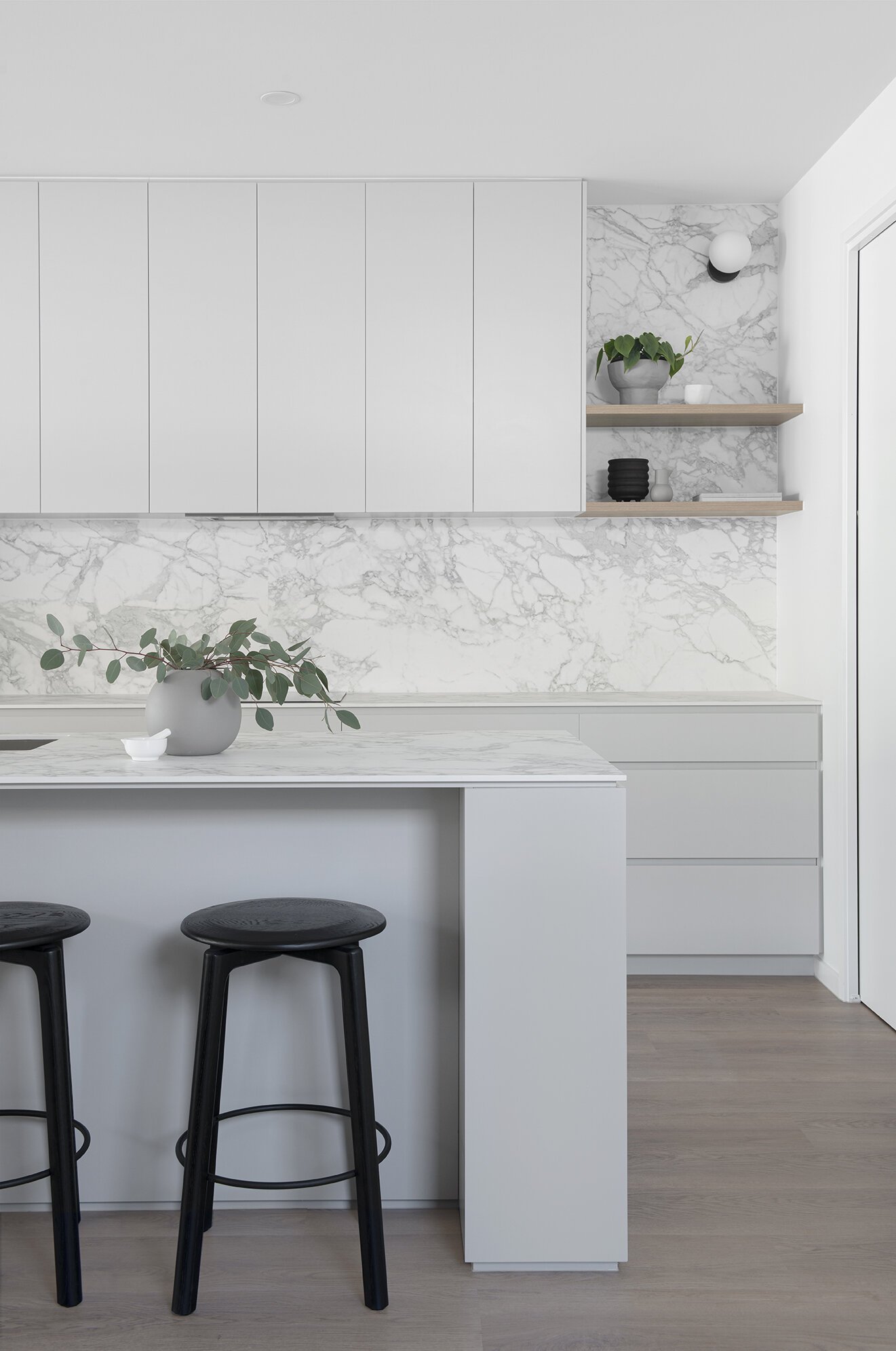 Kitchen white island bench and white plant pot with black stools in retreat house design bundle for home remodel
