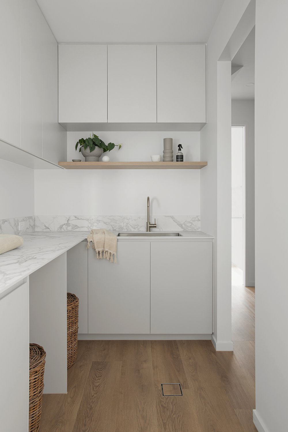 White laundry cabinets with shelf on top and white plant pot in retreat house design bundle for home remodel